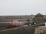 SX14121 RNLI lifeboat being pulled onto harbour slipway by tracktor.jpg